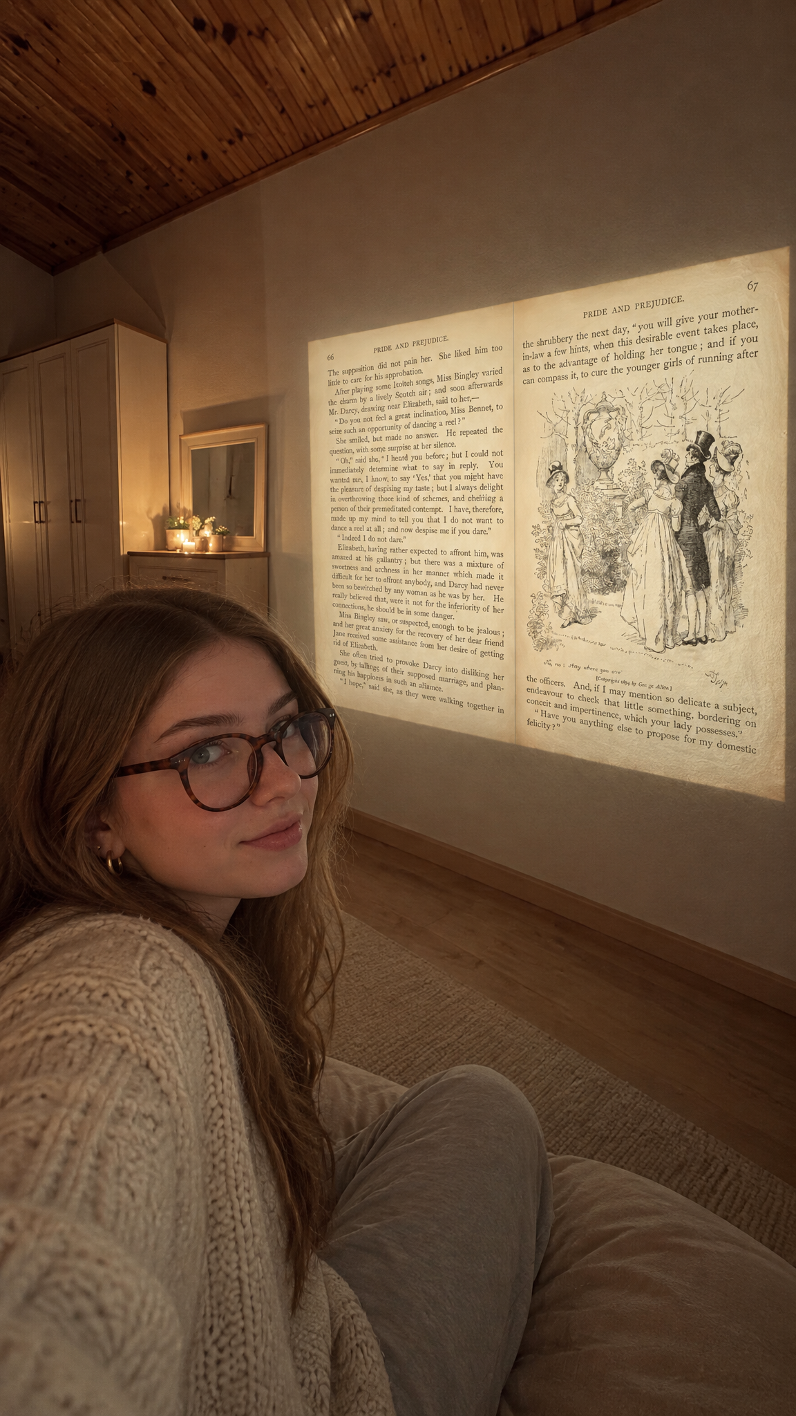 A selfie on a floor cushion with the page projected on the plaster wall behind her